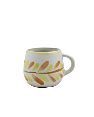 Ceramic mug with leaf pattern on a white background Ceramic mug with leaf pattern on a white background