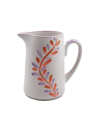 White ceramic pitcher with floral design on a white background White ceramic pitcher with floral design on a white background