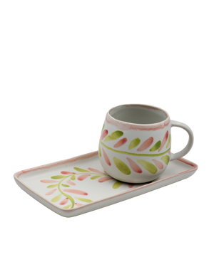 Ceramic mug and tray set with floral patterns on a white background Ceramic mug and tray set with floral patterns on a white background
