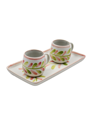 Two ceramic mugs with floral designs on a matching tray against a white background Two ceramic mugs with floral designs on a matching tray against a white background