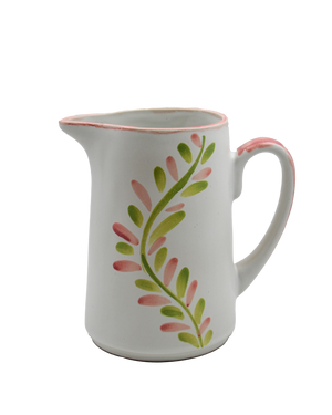 White ceramic pitcher with pink and green leaf pattern on a white background White ceramic pitcher with pink and green leaf pattern on a white background