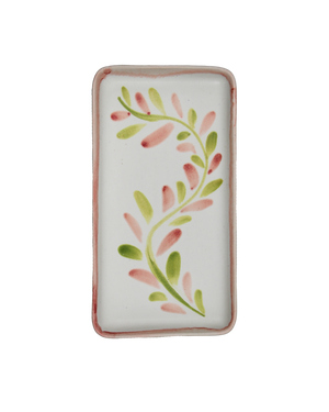 Rectangular white dish with pink and green leaf pattern on a white background Rectangular white dish with pink and green leaf pattern on a white background