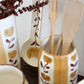 Decorative ceramic utensil holder with wooden utensils and floral patterns.