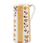 Ceramic pitcher with floral design on a white background