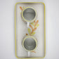 Two ceramic cups with floral design on a white background