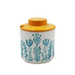 Container with floral design and yellow lid on a white background