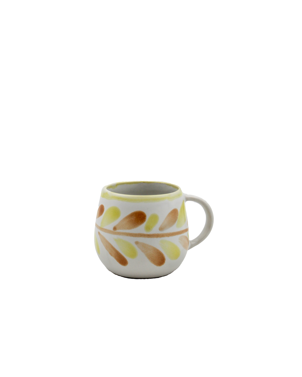 Ceramic mug with leaf pattern on a white background