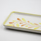 Rectangular ceramic tray with floral design on a white background