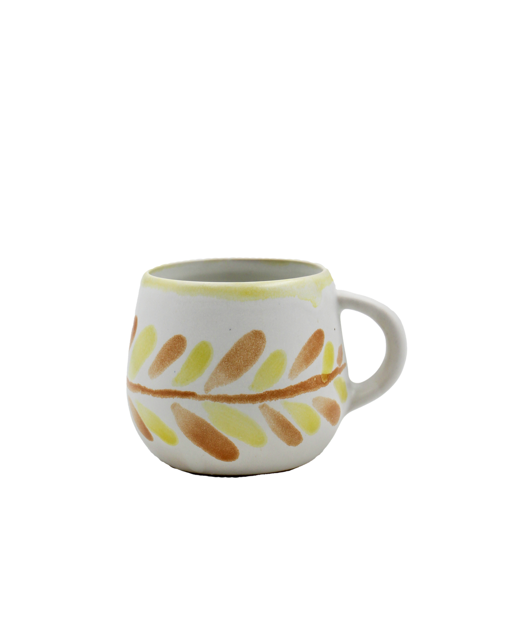 Ceramic mug with leaf pattern on a white background