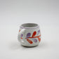 Ceramic mug with floral design on a white background