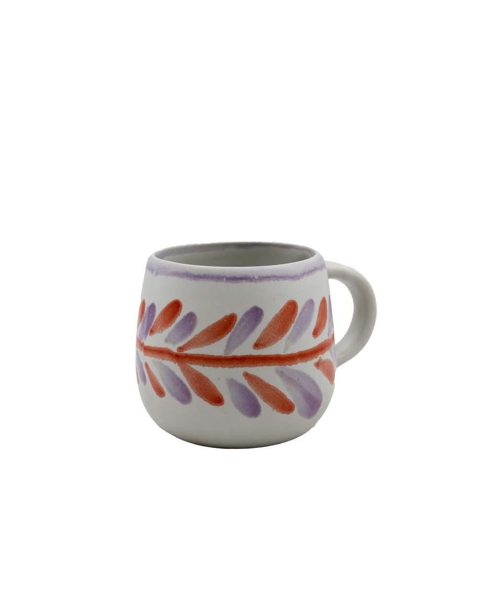 Ceramic mug with colorful leaf pattern on a white background