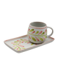 Ceramic mug and tray set with floral patterns on a white background