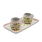 Two ceramic mugs with floral designs on a matching tray against a white background