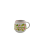 Ceramic mug with floral pattern on a white background