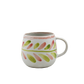 Ceramic mug with floral patterns on a white background
