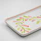 Decorative ceramic tray with floral design on a light gray background